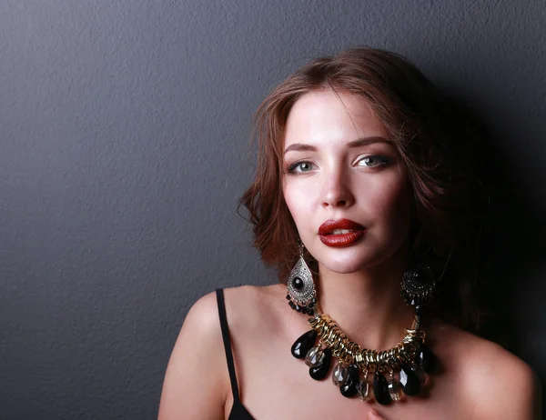 Portrait of young beautiful woman with jewelry — Stock Photo, Image