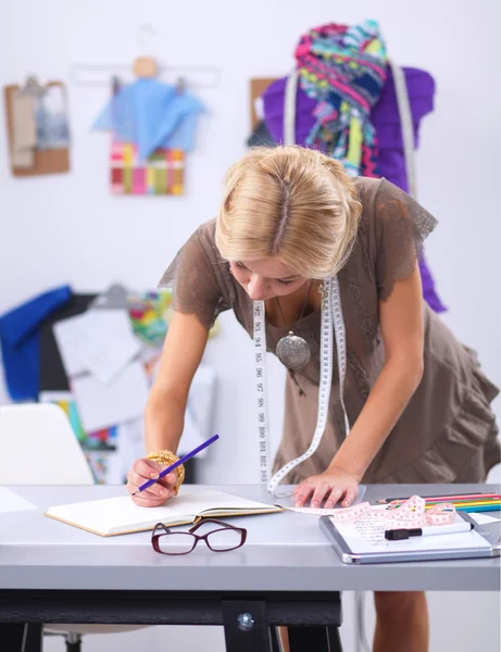 Junge Modedesignerin arbeitet im Atelier. — Stockfoto