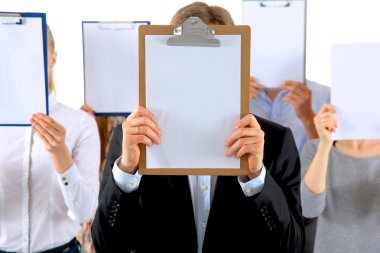 Beyaz arka plan üzerinde izole yüz yakınındaki bir klasörler holding iş adamları ekibinin