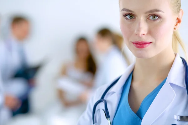 Woman doctor standing with stethoscope at hospital — Stock Photo, Image