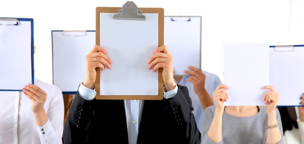 Team of businesspeople holding a folders near face isolated on white background — Stock Photo, Image