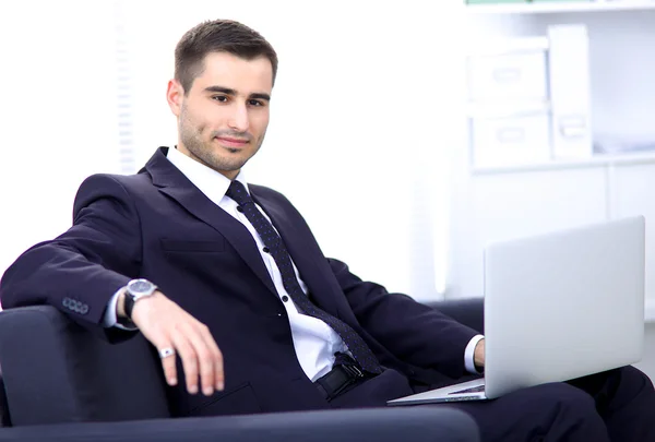 Businessman sitting on sofa in the office — Stock Photo, Image