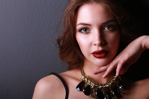 Portrait of young beautiful woman with jewelry — Stock Photo, Image