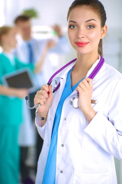 Woman doctor standing with stethoscope at hospital — Stock Photo, Image