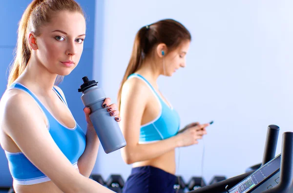 Group of people at the gym exercising on cross trainers — Stock Photo, Image