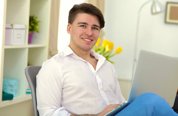 Young businessman working in office, standing near desk — Stock Photo, Image