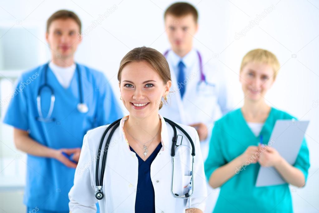 Attractive female doctor in front of medical group