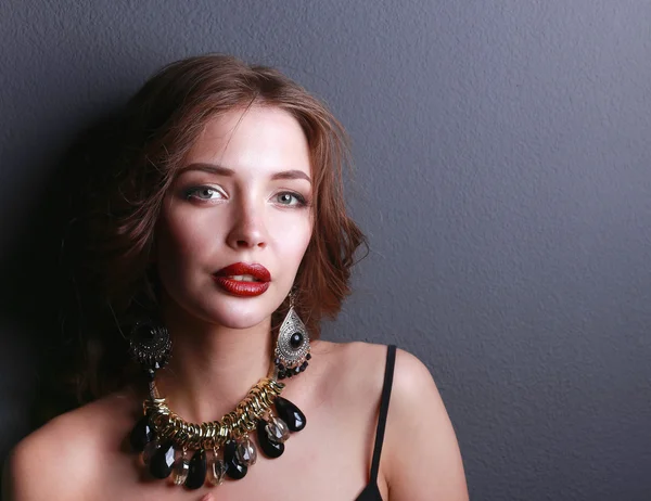 Portrait of young beautiful woman with jewelry — Stock Photo, Image