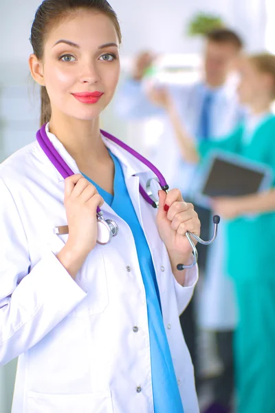 Woman doctor standing with stethoscope at hospital — Stock Photo, Image