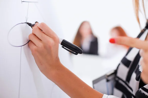 Young woman drawing on wihteboard with white copyspace — Stock Photo, Image