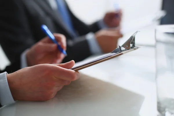 Businesspeople sitting on the desk on office — Stock Photo, Image