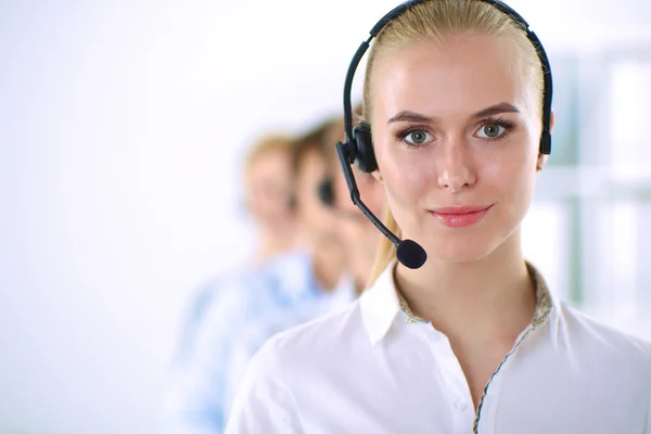 Attractive positive young businesspeople and colleagues in a call center office