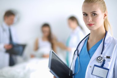 Kadın doktor hastanede dosyayla bekliyor. 