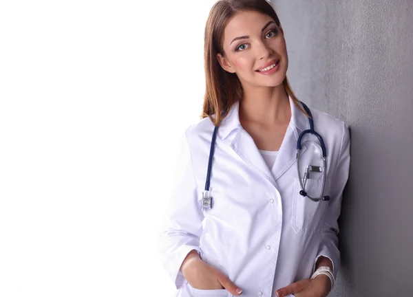 Doctor woman with stethoscope isolated on grey background — Stock Photo, Image