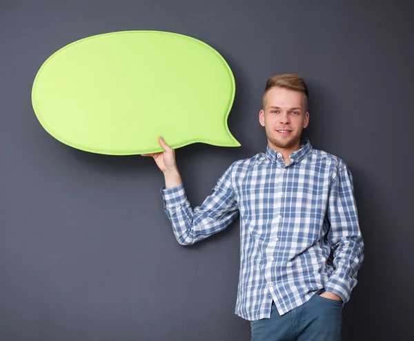 Muž, který držel bílý prázdnou bublinu s prostorem pro text — Stock fotografie