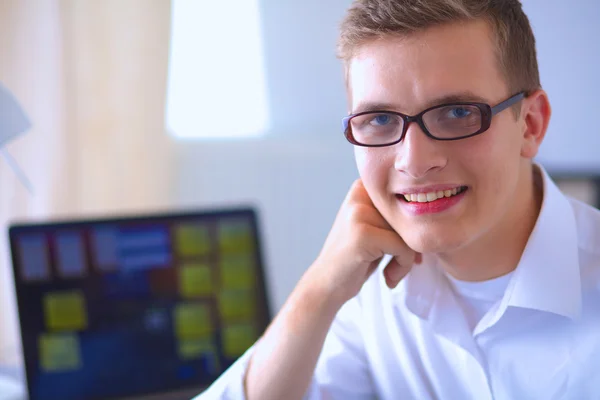 Young businessman working in office, sitting near desk — Stock Photo, Image