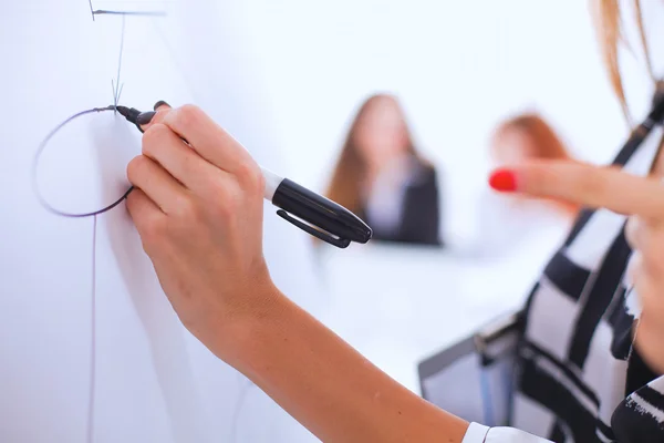 Young woman drawing on wihteboard with white copyspace — Stock Photo, Image
