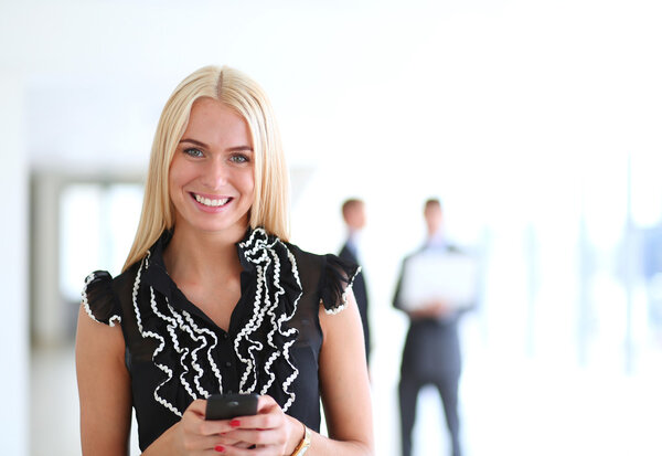 Business woman sending text message from her mobile