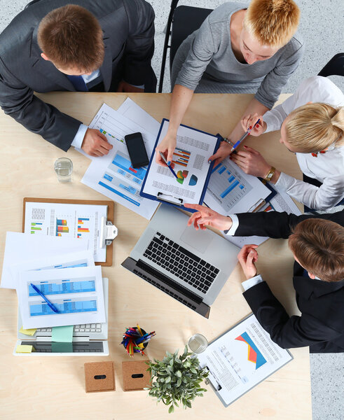 Business people sitting and discussing at business meeting, in office