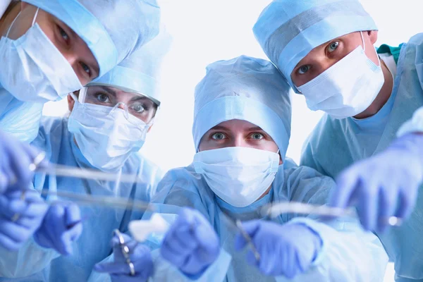 Below view of surgeons holding medical instruments in hands — Stock Photo, Image