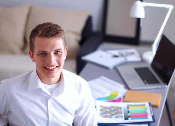 Young businessman working in office, standing near desk — Stock Photo, Image