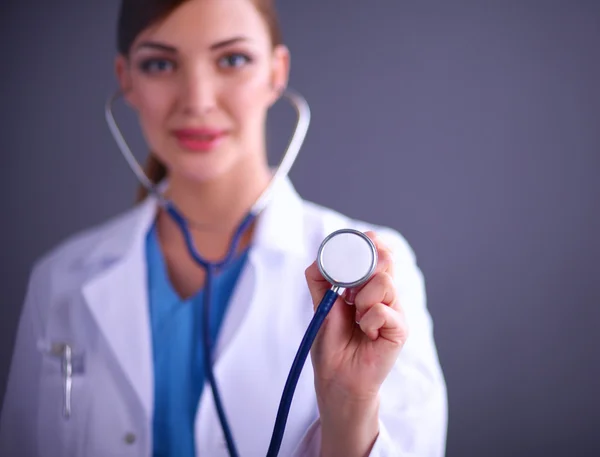 Female doctor with a stethoscope listening, isolated on grey background — Stock Photo, Image