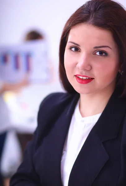 Attractive businesswoman sitting  on desk in the office with cup of coffee — Stock Photo, Image