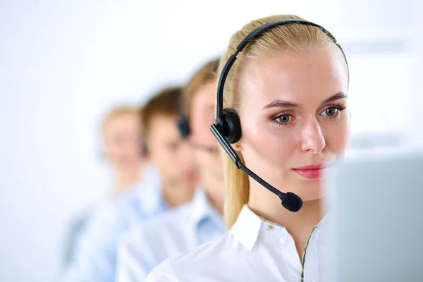 Attractive positive young businesspeople and colleagues in a call center office