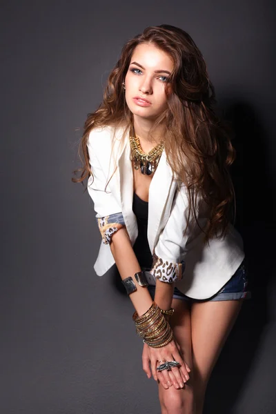 Portrait of young woman with beads, standing on grey background — Stock Photo, Image