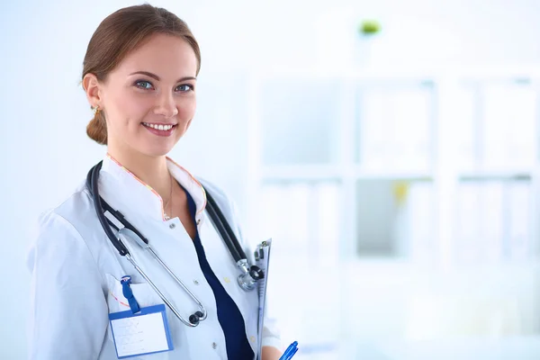 Woman doctor standing with stethoscope at hospital Stock Image