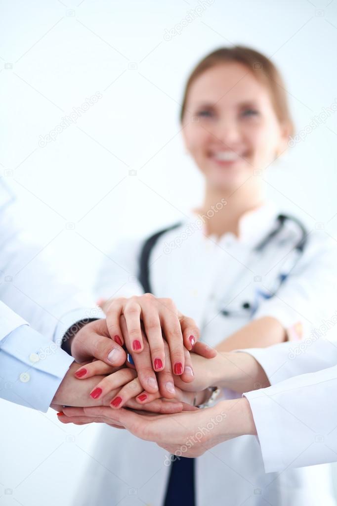 Doctors and nurses in a medical team stacking hands 