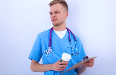 Steteskoplu doktor ayakta, çapraz kollu, beyaz arka planda izole.