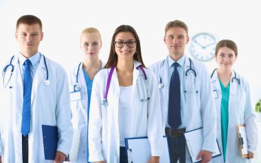 Birlikte ayakta duran bir grup gülümseyen hastane arkadaşının portresi.