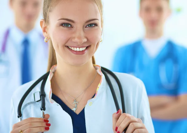 Attractive female doctor in front of medical group — Stock Photo, Image