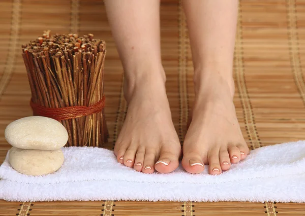 Care for beautiful woman legs on a towel. Beautiful woman legs Stock