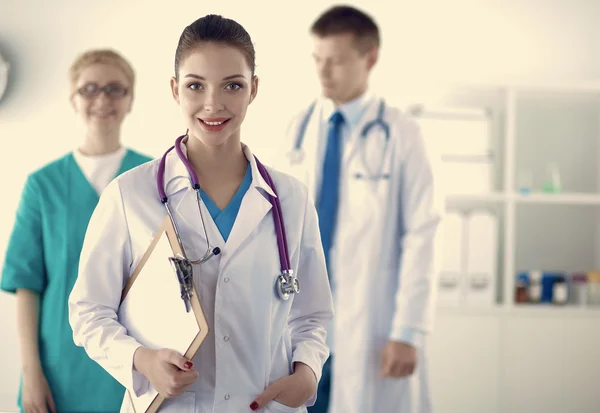 Médica atraente na frente do grupo médico — Fotografia de Stock