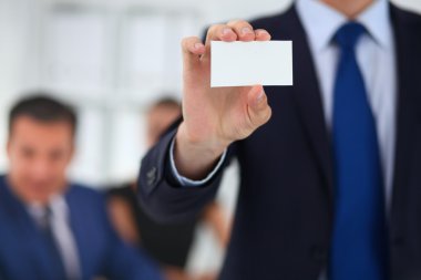 Close-up of a businessman holding a blank business card clipart