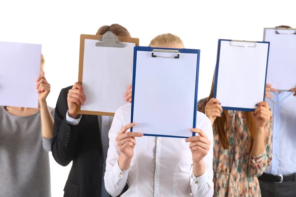 Team of businesspeople holding a folders near face isolated on white background — Stock Photo, Image