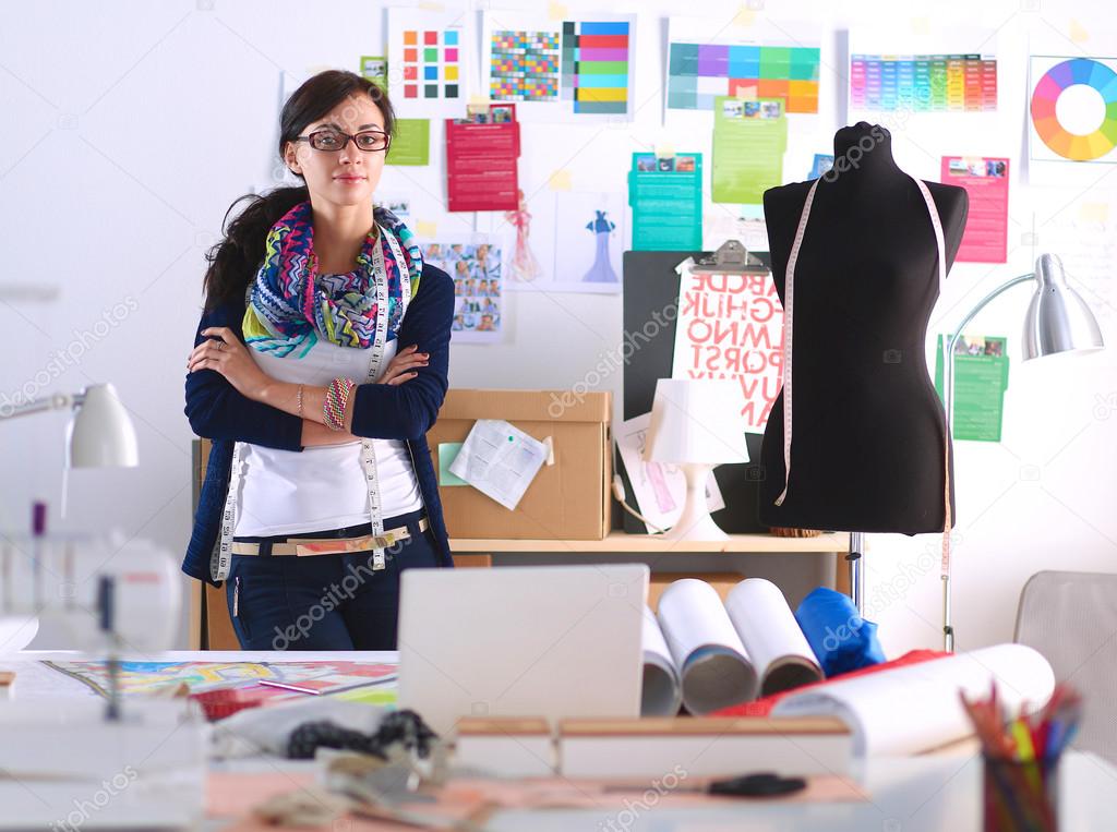 Beautiful fashion designer standing in studio