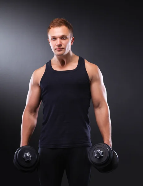 Handsome muscular man working out with dumbbells — Stock Photo, Image