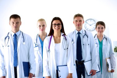 Birlikte ayakta duran bir grup gülümseyen hastane arkadaşının portresi.