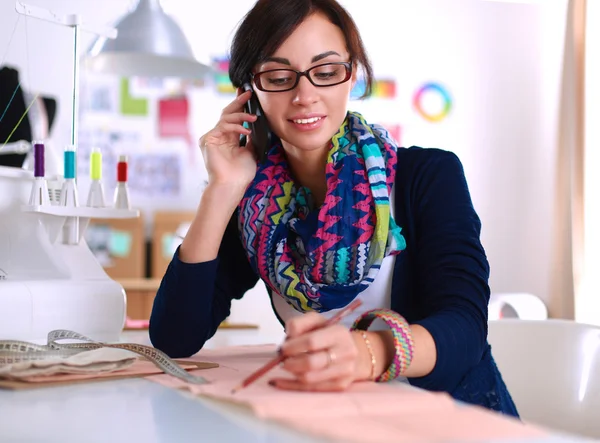 Dressmaker designing clothes pattern on paper — Stock Photo, Image