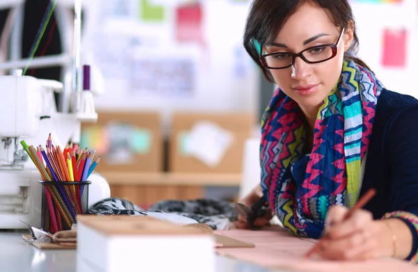 Dressmaker designing clothes pattern on paper — Stock Photo, Image