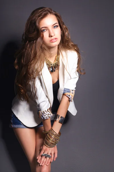 Portrait of young woman with beads, standing on grey background — Stock Photo, Image