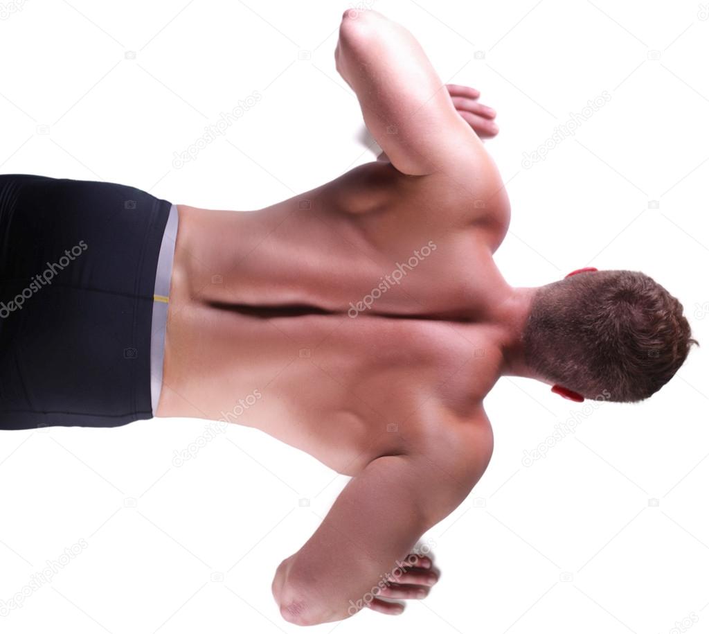 Fitness man doing push ups on floor