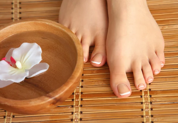 Care for beautiful woman legs with flower — Stock Photo, Image