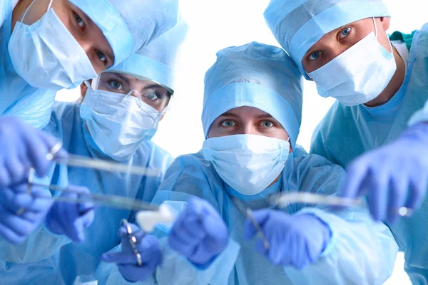 Below view of surgeons holding medical instruments in hands — Stock Photo, Image