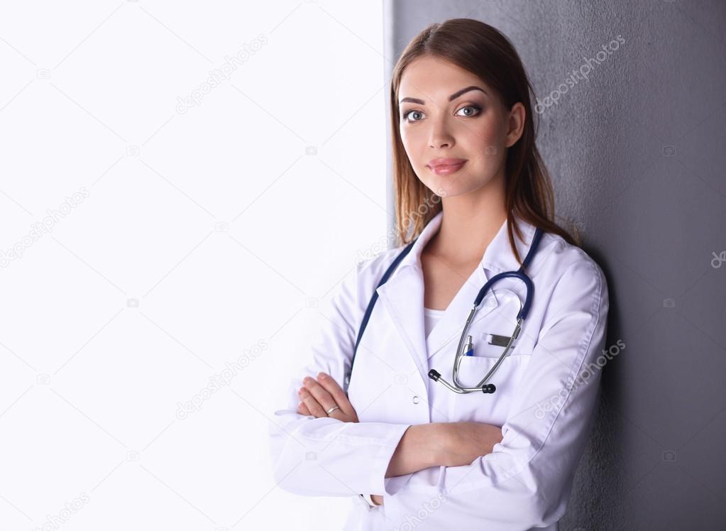 Doctor woman with stethoscope isolated on grey background