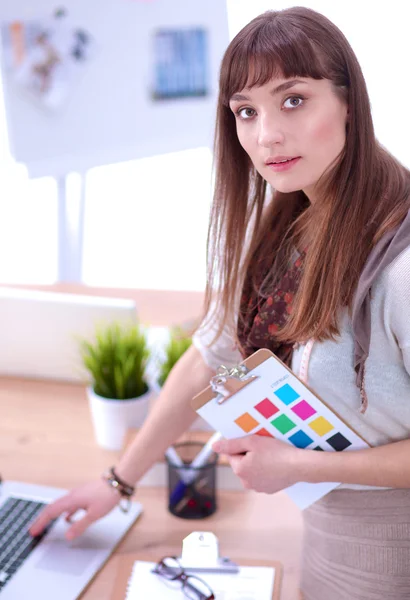 Portrait of attractive female fashion designer sitting at office desk — Stock Photo, Image