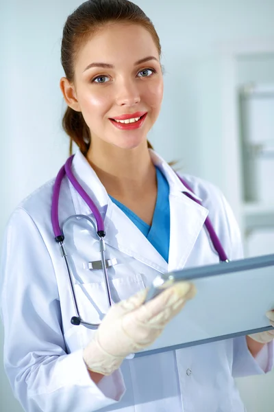 Woman doctor standing with folder at hospital — Stock Photo, Image